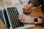 Hands typing on a computer