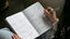 woman writing in goal planner