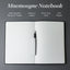 Mnemosyne Notebook with a pen on a gray background