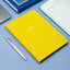 Prompt Journal yellow on a blue surface