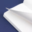Close-up of a white notebook with a blue background