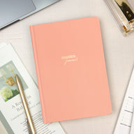 Pink Mantra Journal on a desk