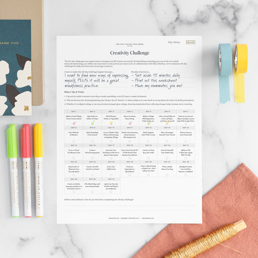 Riley Sheehey's creativity challenge worksheet on a marble tabletop next to markers and colorful washi tape.