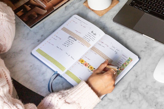 woman writing in a planner