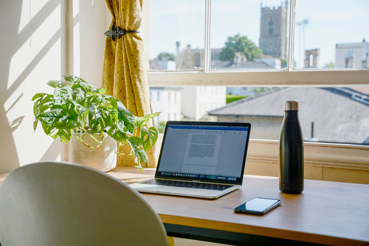 A clean bright desk in front of a window
