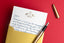 Hand written thank you note on a red background