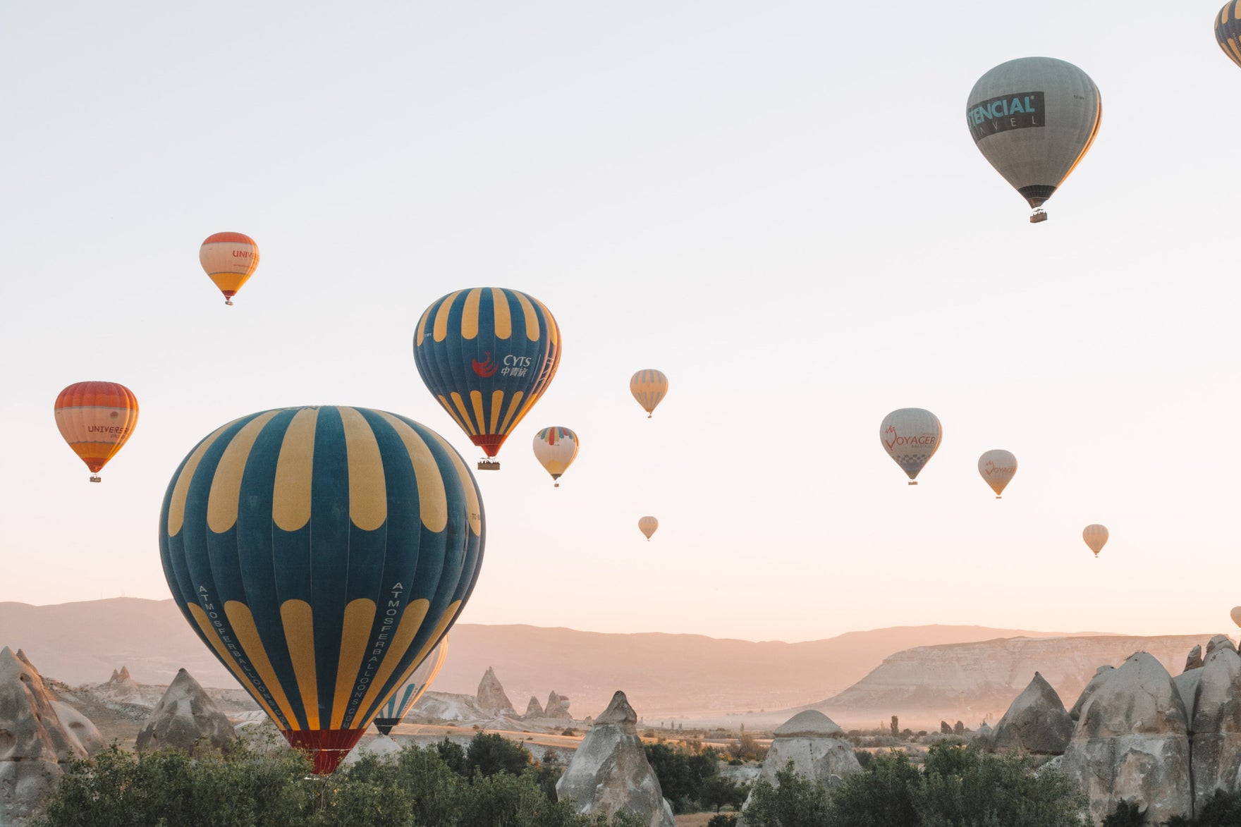 A sky filled with hot air balloons taking off