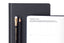 A planner open to a prompt page and two black pencils