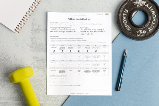 Traci Copeland’s 30-Day Home Workout Challenge Worksheet next to a yoga mat, hand weight, and disc weight.