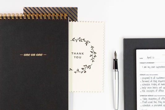 An array of white, grey, and gold office gifts for administrative professionals day.