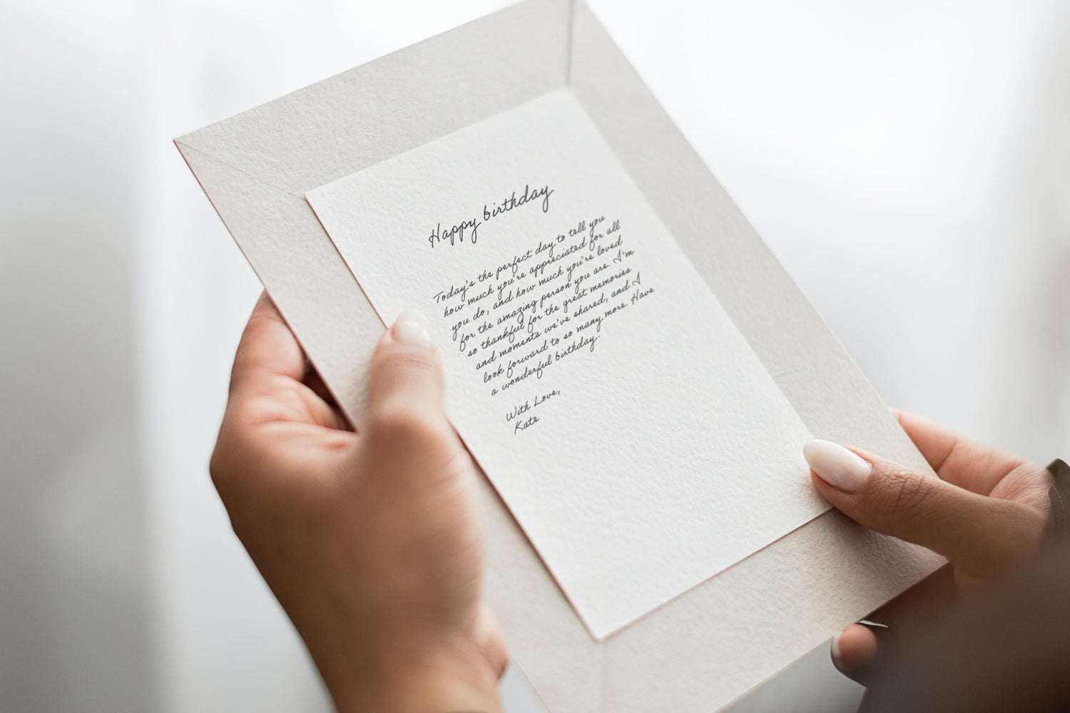 person holding a card with a birthday message written on it