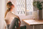 A woman sitting at a table looks stressed