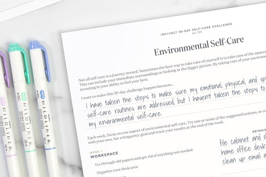 An environmental self-care worksheet on a white table next to three markers