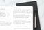 a fitness journal with smart fitness goals written in it, lying on top of another journal on a white table
