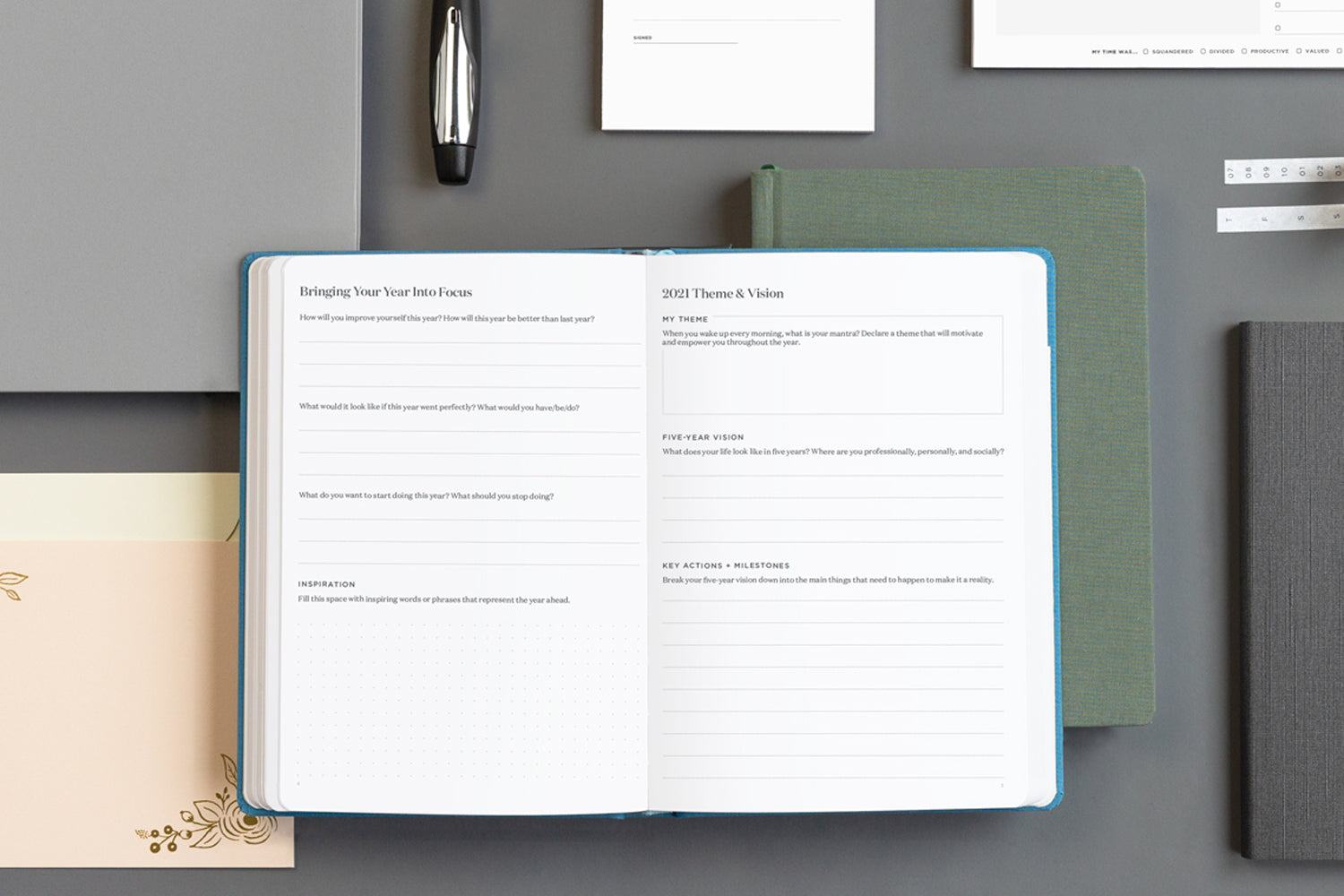 an array of tools for how to get organized - a planner, notebooks, and pens on a desk.