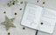 An Ink+Volt Planner is open on a table surrounded by star confetti