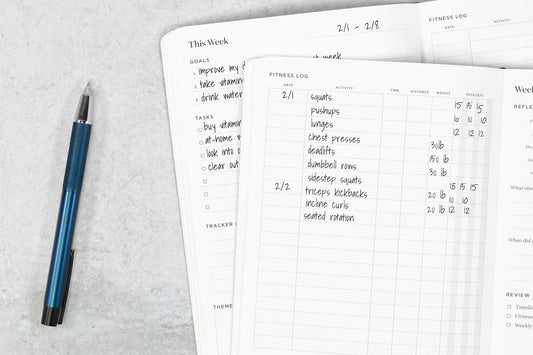 Ink+Volt fitness planner open with pen