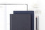 An array of customizable productivity tools: a planner, two notebooks, pencils, and paper clips. 