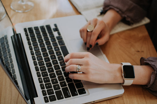 Hands typing on a computer