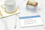 A cup of tea next to a morning to-do list on a white countertop