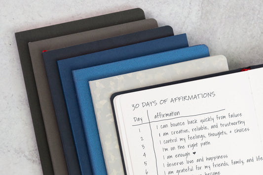 A stack of notebooks on a white counter