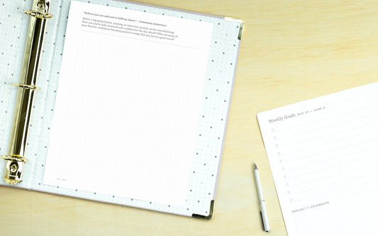 A binder with Ink+Volt's 2020 Planner PDF pages lies open on a table