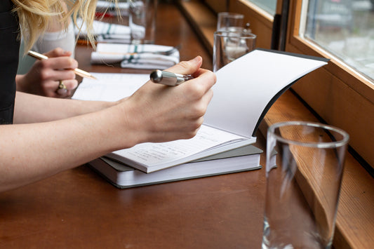 Writing in a Notepad at a cafe