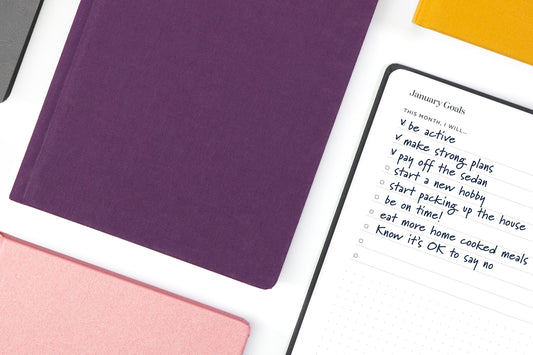 A list of priorities in a planner, next to an array of colorful planners.