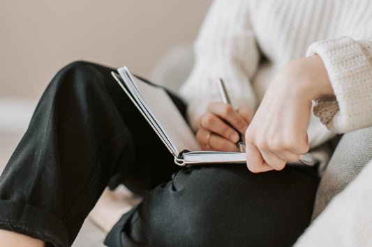 woman writing in a journal