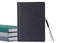 A stack of planners and a pen on a white background