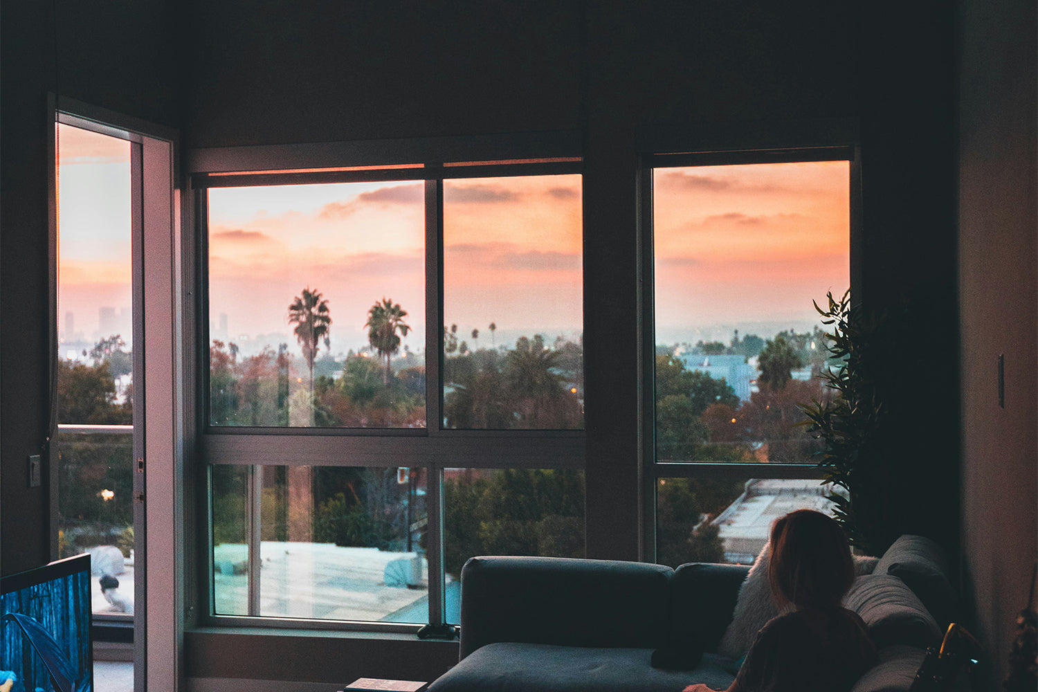 A large window looking out onto a sunset