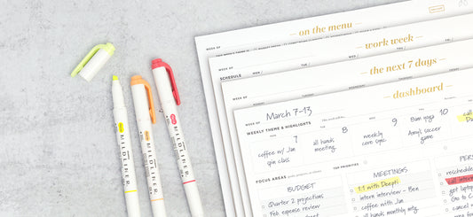 A stack of priority planning pads next to three colorful markers