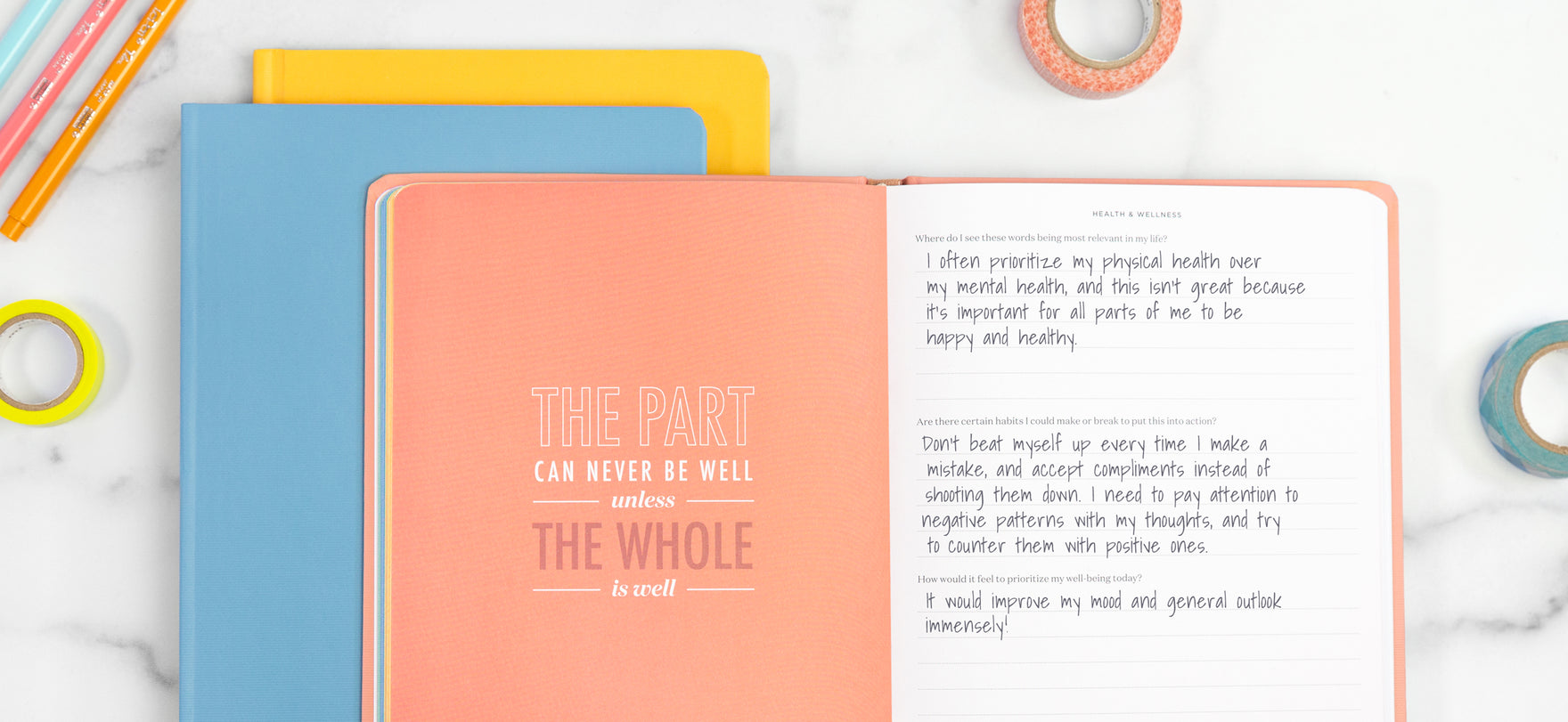 A pink mantra journal is open to an encouraging quote about taking care of yourself.