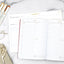 Two scheduling notepads sit open on a white marble tabletop