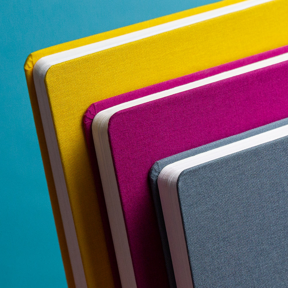 The colorful planners in front of a blue background