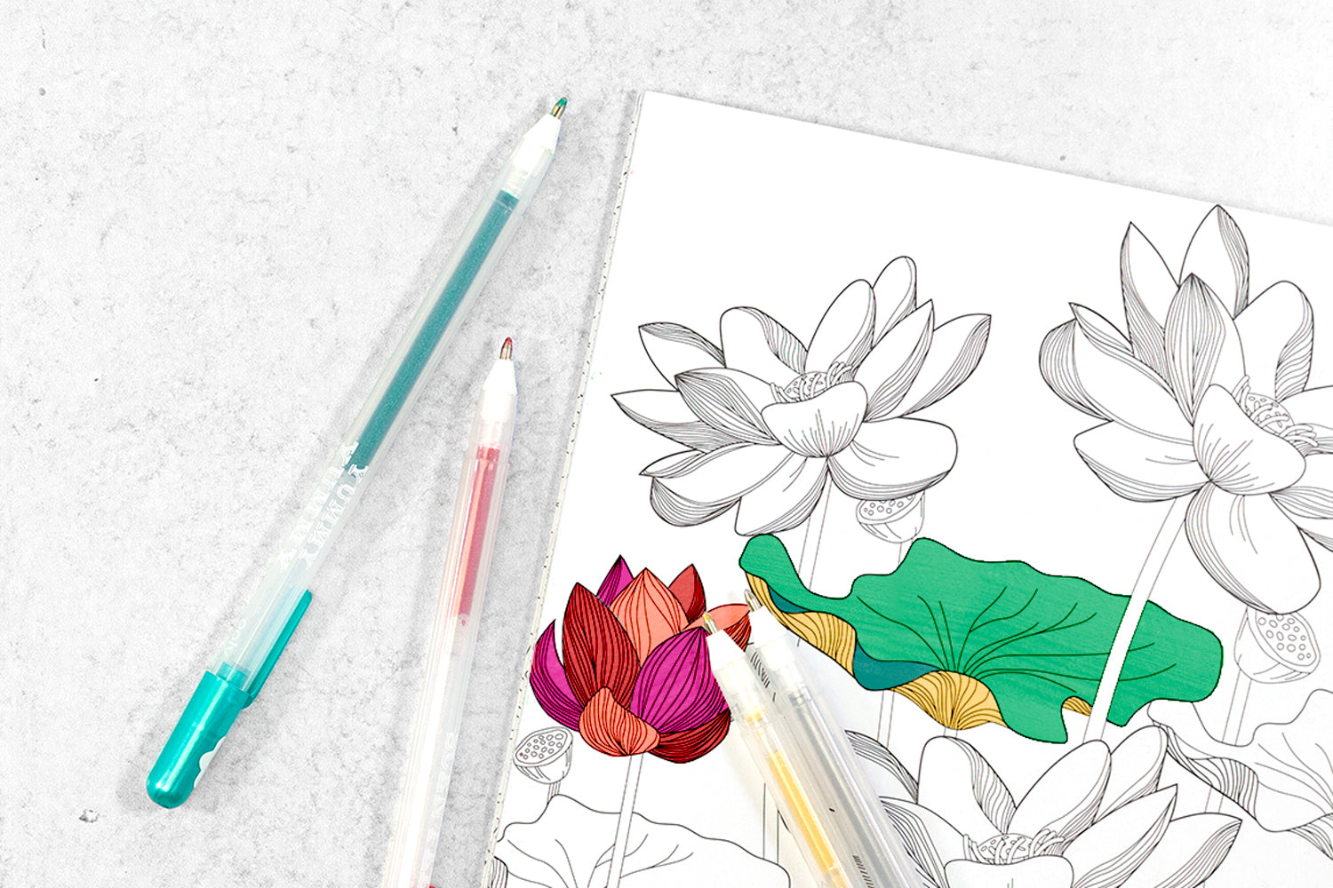 A colorful coloring book page with flowers on it and two pens next to it.
