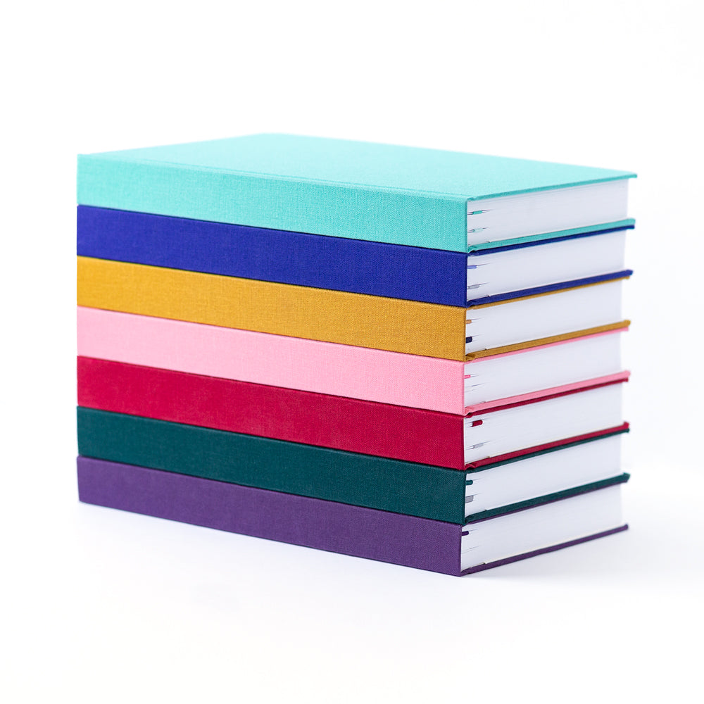 A stack of bright, colorful planners.