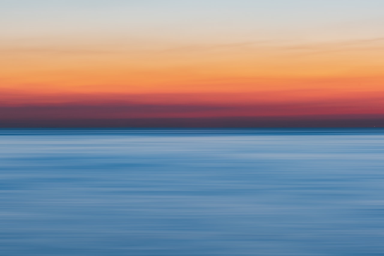An array of horizontal sunrise colors, from blue to orange to white