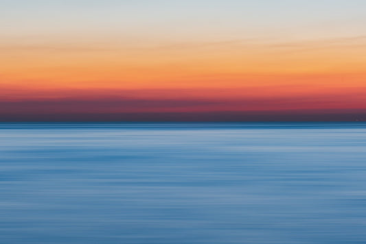 An array of horizontal sunrise colors, from blue to orange to white