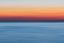 An array of horizontal sunrise colors, from blue to orange to white
