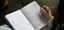 woman writing in goal planner