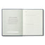 Open book with text and lined pages on a white background