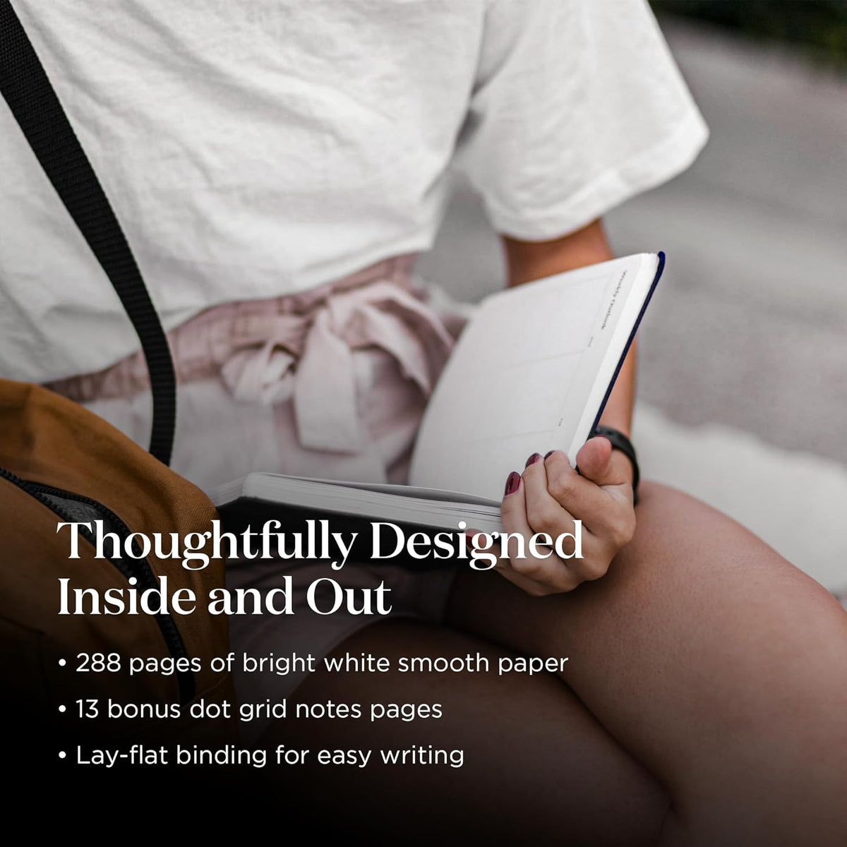 Person holding a notebook with text about its features