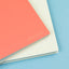 Two notebooks, one pink and one beige, on a blue background with 'SEPTCOULEUR' branding.