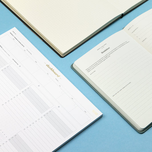 Open planners on a blue surface