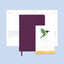Purple planner with a stand and calendar on a light blue background