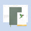 Green planner with a stand and calendar on a light blue background