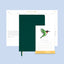 Green notebook with a stand and calendar on a light blue background