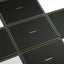 A close-up of a black spiral-bound notebook or planner with gold text reading "dashboard -" and a gold spiral edge, arranged in a tiled pattern on a white background.