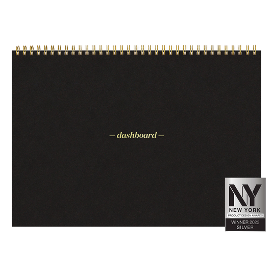 Black spiral-bound notebook with 'dashboard' branding and a New York Product Design Award badge.